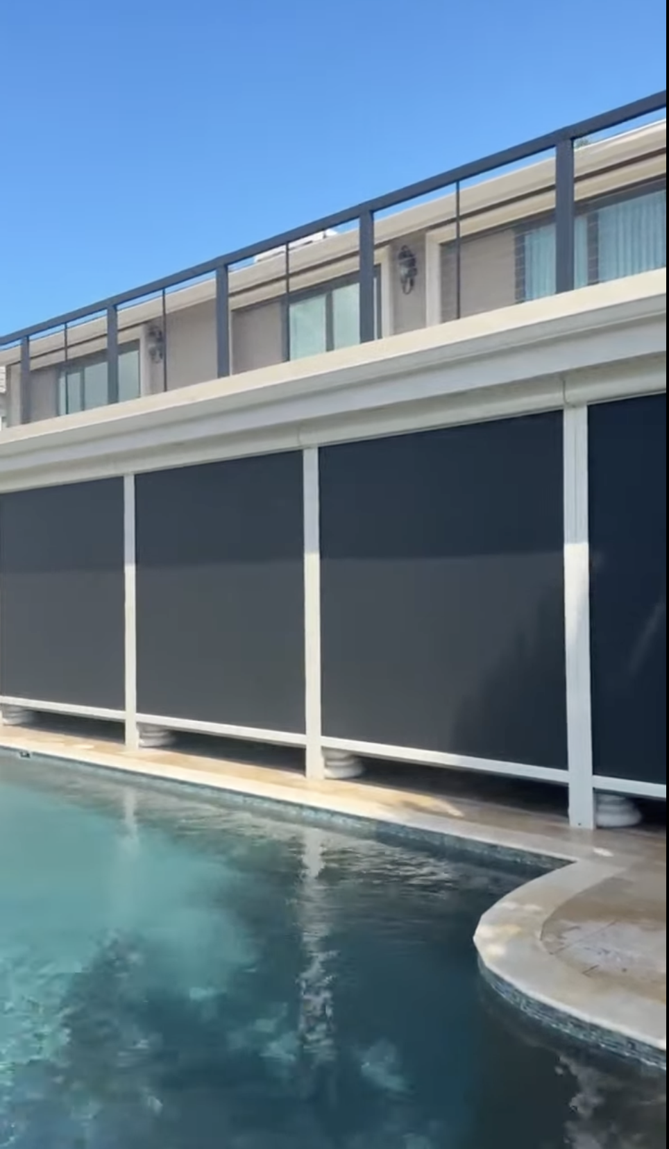 Defender hurricane screens deployed across a poolside lanai